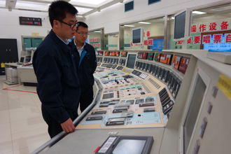 Managing knowledge and experience is key to safe and sustainable operations. Here, two engineers at a control room at China's Qinshan NPP. (Photo: CNNC)