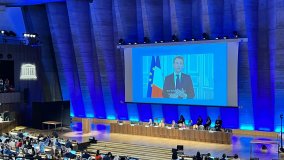 President Emmanuel Macron of France speaks via video recording at the Second Session of the Intergovernmental Negotiating Committee on Plastic Pollution in Paris, France, 29 May 2023. (Photo: P. Bersuder/IAEA)