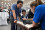 Enthusiastic children and adults look on as experts show how the IAEA uses surveillance cameras and seals to verify that nuclear material and equipment remain in peaceful use, and how they swipe surfaces to collect traces of particles that reveal information about possible prior use of nuclear material at a location.  