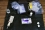 Officers place the equipment for evidence recovery and contamination monitoring close to, but outside of the crime scene. The equipment includes a contamination meter, evidence packaging, extenders for collecting evidence at a safe distance, and cotton swabs for checking contamination of the evidence packaging.