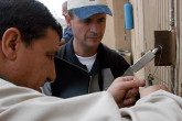 IAEA inspectors check a seal on a bunker with high explosives. Photo Credits: Pavlicek/IAEA