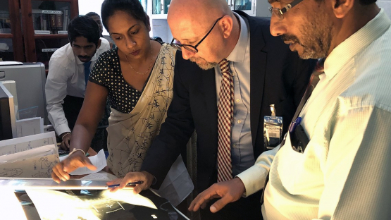 An expert reviewing an x-ray with cancer control staff at the Karapitiya Teaching Hospital in Sri Lanka
