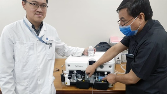 1.	Phong Truong, an international expert, and Dr Irfan Khan prepare the synthesizer for installation at INMOL